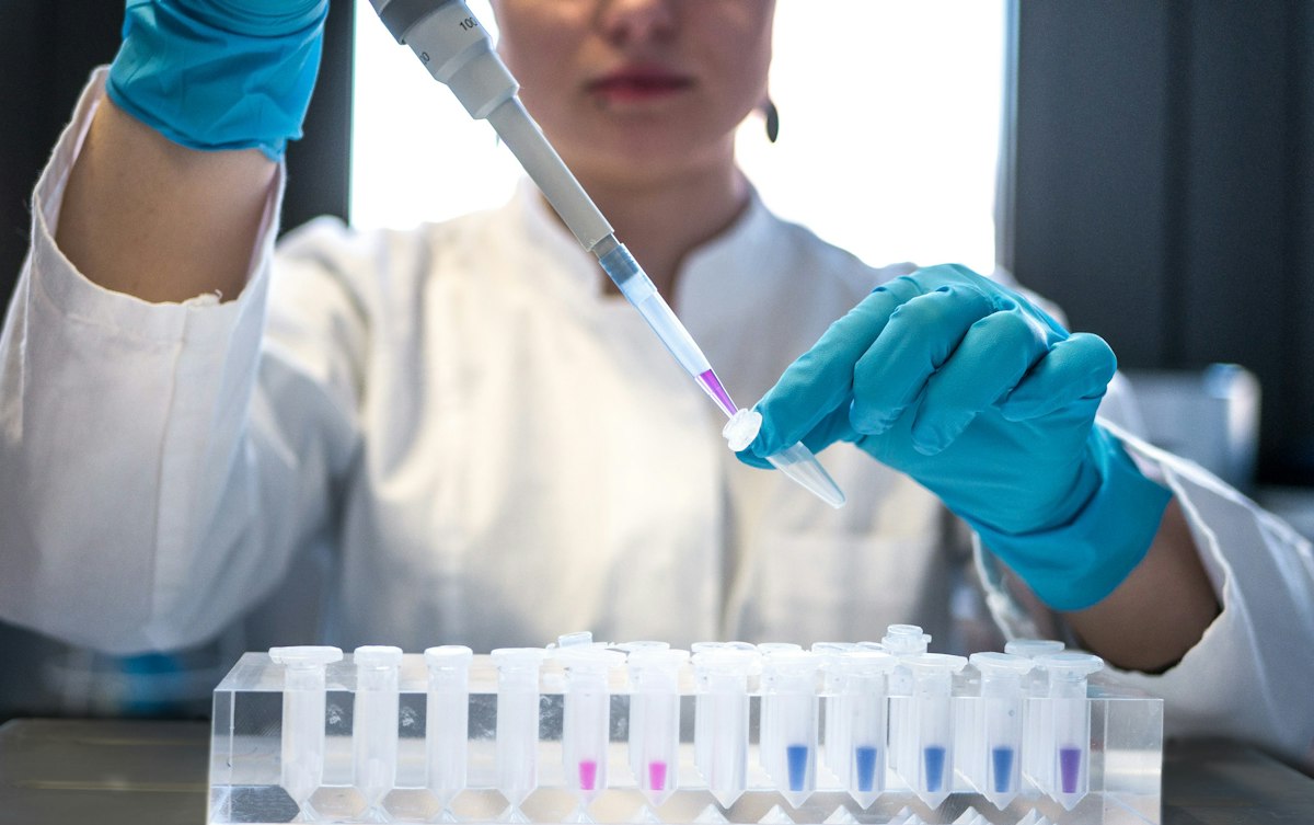 Researcher pipetting samples into vials